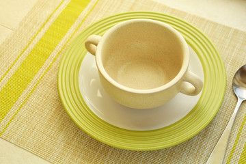 tureen, plate and spoon on the table