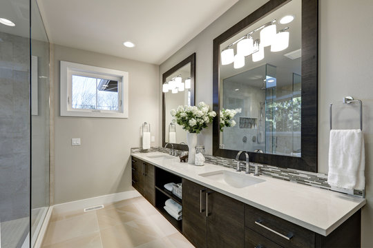 Spacious bathroom in gray tones wizth long vanity