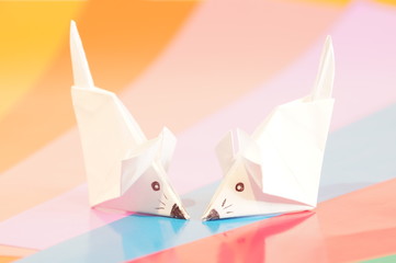 Paper origami mouse isolated on the colorful background