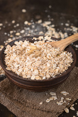 Oat flakes in ceramic bowl.