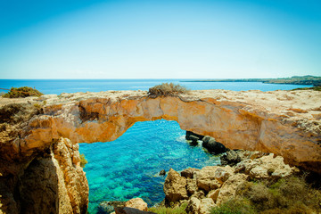 It is a beautiful landscape of rock against the sea