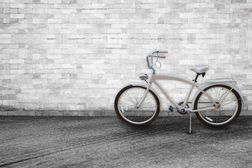 Fototapeta na wymiar Bicycle on background of old vintage White brick wall on road