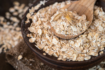 Oat flakes in ceramic bowl.