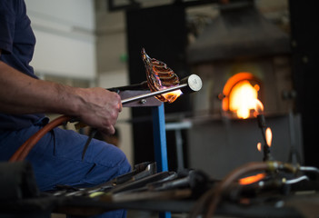 man, professional glass blower working in workshop