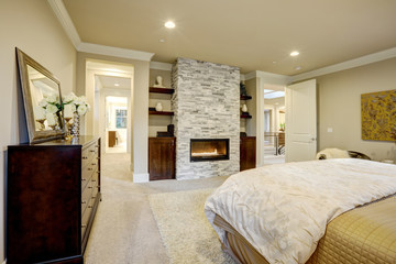 Fototapeta na wymiar Master bedroom with stone fireplace