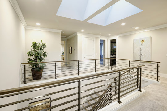 Second floor landing features skylight over the staircase
