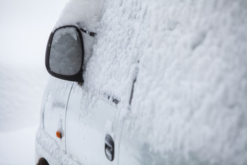 Snow-covered car mirror