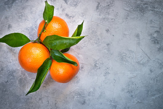 Tangerines fruit on grey concrete table. Top view © nadianb