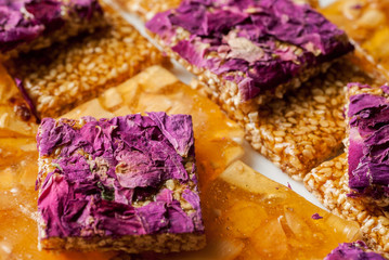 Pile of oriental sweets with nuts, seeds and rose petals