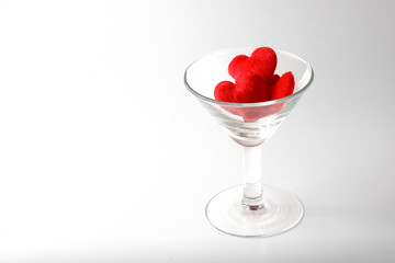 Red heart in a glass of martini isolated on white background with clipping path
