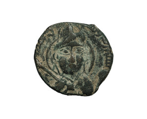 Ancient copper islamic coin with face on it isolated on white
