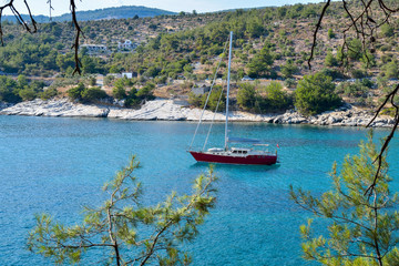 Sailing ship in the bay of the beautiful Aliki beach, Thassos island, Greece
