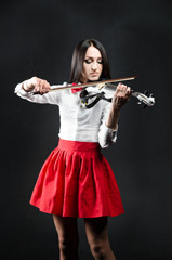 Woman in skirt and blouse playing the violin