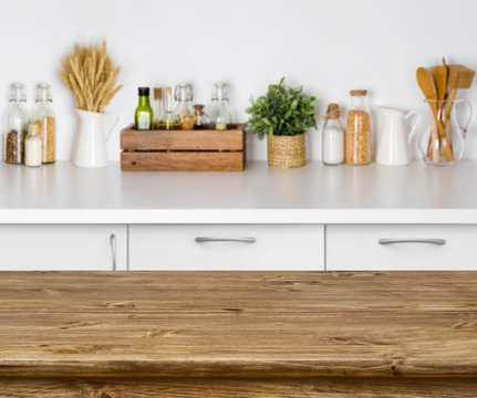 Brown wooden table with bokeh image of kitchen bench interior