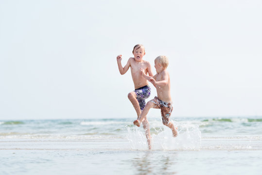 Two boys running on beach