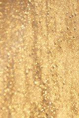 Abstract gold glitter background. Twinkled texture. Bokeh ligh