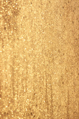 Abstract gold glitter background. Twinkled texture. Bokeh ligh