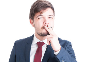 Man wearing suit enjoying smoking a cigarette