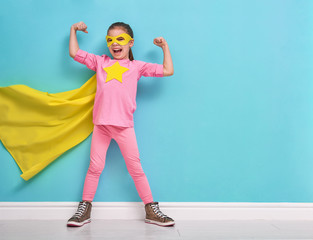 child plays superhero