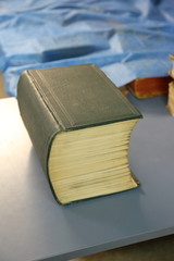 The big book in a green leather hardcover on the table