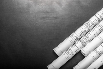 Construction planning drawings on black background