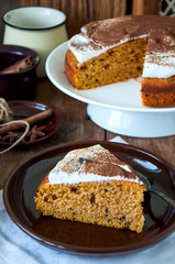 Spicy pumpkin pie with whipped merengue frosting sprinkled with cocoa powder