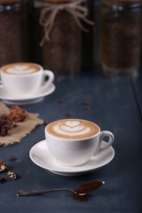 Two cups of coffee on a blue background