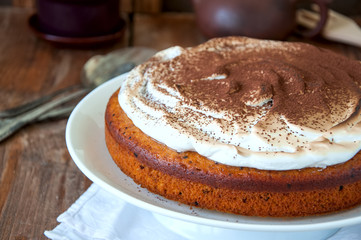 Spicy pumpkin pie with whipped merengue frosting sprinkled with cocoa powder