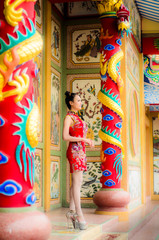 Beautiful  Asian girl wear cheongsam and show something to you in chinese new year