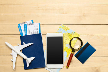 Travel objects on wooden background