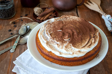 Spicy pumpkin pie with whipped merengue frosting sprinkled with cocoa powder