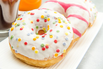dish with assorted donuts, coffee and juice