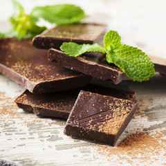 Brown chocolate and mint on the wooden table