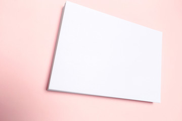 Obraz na płótnie Canvas Blank paper on top of pink pastel desk