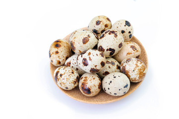 Obraz premium quail eggs on a plate isolated on white background