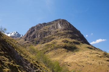 Mountain at Glencoe Scotland UK in Scottish Highlands in spring with sunshine and snow