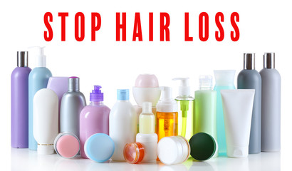 Text STOP HAIR LOSS and set of cosmetic products on white background