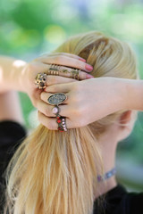 Woman setting hair. Beautiful rings on female hands