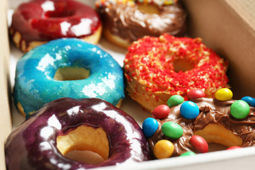 Delicious donuts in box, closeup