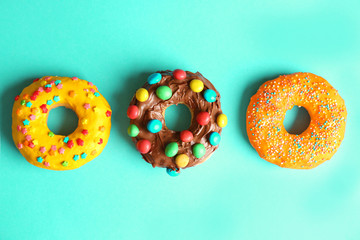 Glazed donuts on color background