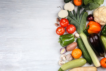 Fresh vegetables on wooden background, top view