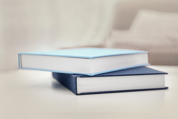 Pile of books on white table, closeup