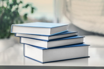 Pile of books on white table, closeup