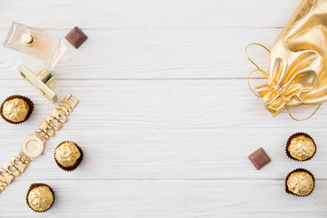 Women's set of accessories and sweets in golden color 