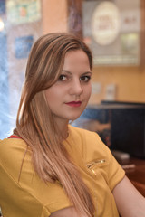 Portrait of a beautiful young woman sitting in a cafe