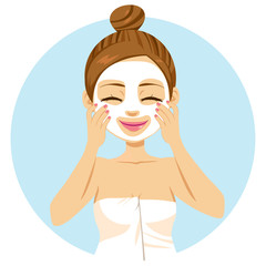 Cute beautiful young woman applying facial mask treatment
