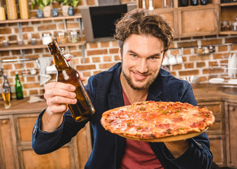 man with beer and pizza