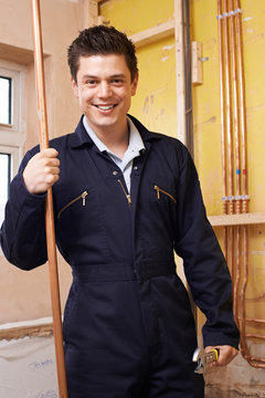 Portrait Of Male Plumber Working In House
