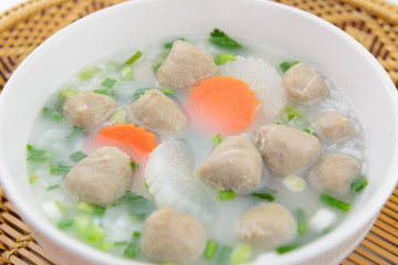 boiled rice with meat ball and vegetable in a white bowl, thai style food