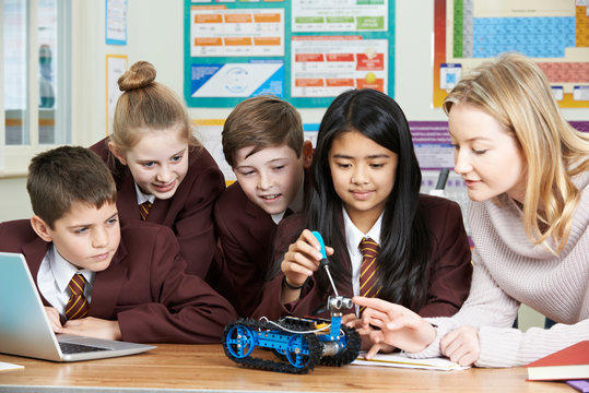 Pupils And Teacher In Science Lesson Studying Robotics